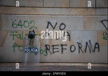 Bogota, Kolumbien. Mai 2021. Ein ESMAD-Sturzschild und ein Helm sind über einer Wand mit der Aufschrift „Nein zur Steuerreform“ angebracht, während Bürger und Demonstranten den Kongressbeistand unterstützen, in dem Verteidigungsminister Diego Molano in Motion of No Confidence (Motion Censor) gebracht wurde. Nach den Fällen von Polizeibrutalität im ersten Monat der Proteste in Kolumbien, die jetzt mindestens 45 Tote bei Polizei- und Behördenfällen erreichen. Am 24. Mai 2021 in Bogota, Kolumbien. Kredit: Long Visual Press/Alamy Live Nachrichten Stockfoto