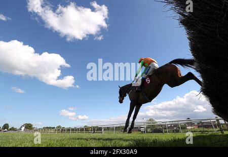 Loch Garman Aris wird von dem Jockey Tom Scudamore gefahren, um auf dem Weg zum Gewinn der Tallarn Green Handicap Chase auf der Rennbahn Bangor-on-Dee einen Zaun zu räumen. Bilddatum: Dienstag, 25. Mai 2021. Stockfoto