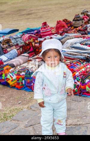 Ein süßes, lokales Quecha-Mädchen auf dem Webmarkt in Chinchero, einem kleinen rustikalen Dorf der Anden im Heiligen Tal, Provinz Urubamba, Region Cusco, Peru Stockfoto