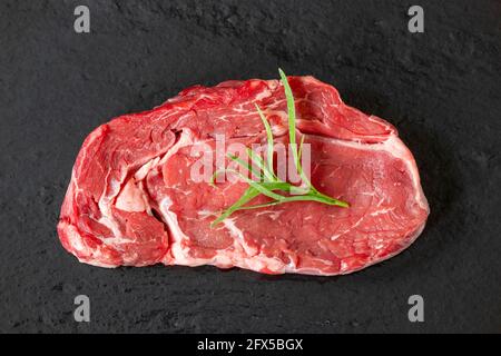 Übersicht über ein rohes Steak auf schwarzer Scheibe Stockfoto