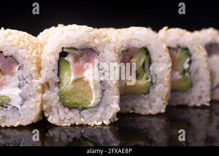 Japanische Sushi-Brötchen mit Frischkäse mit rotem Fisch und Gurke Stockfoto