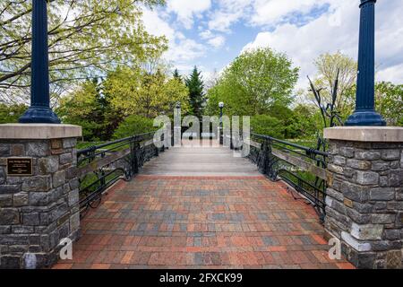 Frederick, MD - 19. April 2021: Die Eiserne Brücke im Stadtzentrum von Carroll Creek Park verfügt über ein Eisengeländer mit einer Flora und Fauna im Jugendstil. Stockfoto