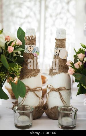 Dekoriert Champagner Flaschen, Gläser und Blumen. Hochzeit Thema Stockfoto