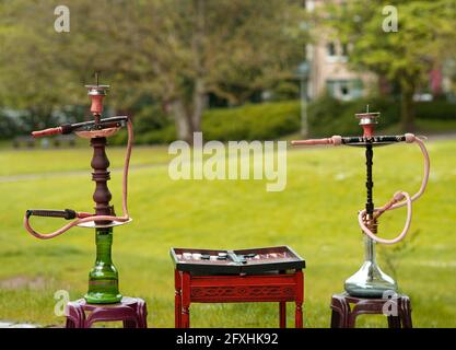 Der Kopf einer Shisha, Wasserpfeife oder Shisha mit glühender Kohle im Garten im Sommersonnenschein Deutschland, Kopf, Wasserpfeife, Rauchen, Arabeske Stockfoto