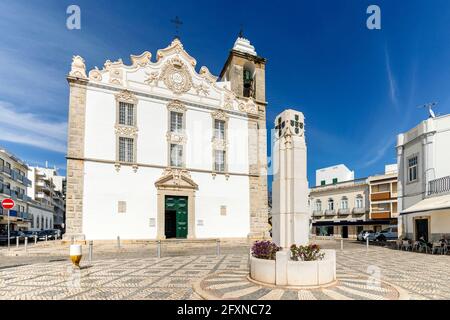 Platz mit weißer, alter Kirche und Denkmal in Olhao, Algarve, Portugal Stockfoto