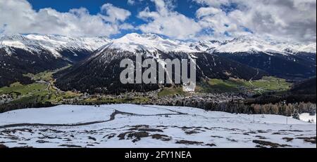 Panoramabild von der schatzalp oberhalb von davos. Blick auf die Stadt Davos mit den verschneiten Bergen im Frühling Stockfoto