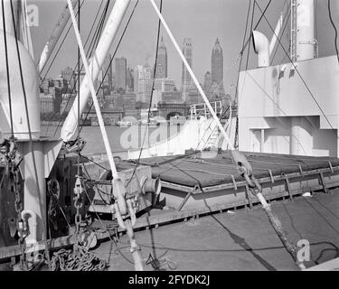 WOLKENKRATZER IM STADTZENTRUM DER 1940ER JAHRE, DIE SKYLINE VON DECK DES FRACHTERS, DER NAVIGIERT HUDSON RIVER NEW YORK CITY NEW YORK USA - R2378 HAR001 HARS NORTH AMERICAN STRUCTURE PROPERTY EXTERIOR NYC IMMOBILIEN NEW YORK STRUKTURIERT STÄDTE GEBÄUDE NEW YORK CITY FRACHTSCHIFFFAHRT SCHWARZ-WEISSE KABEL AM WASSER, HAR001, LOWER MANHATTAN, ALTMODISCH WOLKENKRATZER SCHIFF Stockfoto