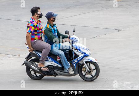 SAMUT PRAKAN, THAILAND, JULI 25 2020, EIN Taxifahrer auf einem Motorrad fährt mit einem Mann. Der mototaxi-Fahrer trägt einen Beifahrer. Stockfoto