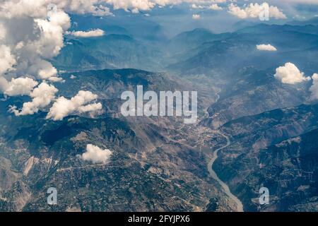 Luftaufnahme der himalaya-Berge von Ladakh, grüne Landschaft mit Berggipfeln und Indus Fluss fließt unter, Himmel mit Wolken im Hintergrund, Junge Stockfoto
