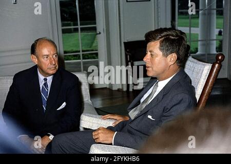 3. August 1961 Präsident John F. Kennedy (im Schaukelstuhl) trifft sich mit dem Botschafter der Vereinigten Staaten bei den Vereinten Nationen Adlai E. Stevenson im Oval Office im Weißen Haus, Washington, D.C.. Er wuchs in Bloomington, Illinois, auf und war Mitglied der Demokratischen Partei.[1] in den 1930er und 1940er Jahren war er in zahlreichen Positionen in der Bundesregierung tätig, darunter in der Agricultural Adjustment Administration, der Federal Alcohol Administration, dem Department of the Navy und dem State Department. 1945 war er Mitglied des Ausschusses, der die Vereinten Nationen gegründet hat. Stockfoto