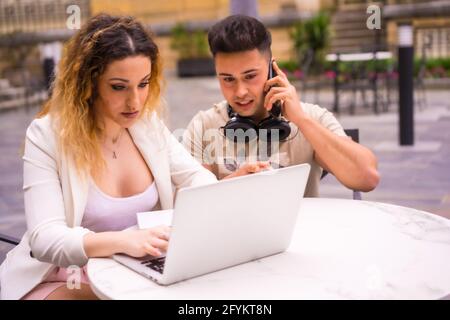 Spanisches Paar Unternehmer, die mit einem Computer arbeiten - das Konzept der Teamarbeit Stockfoto