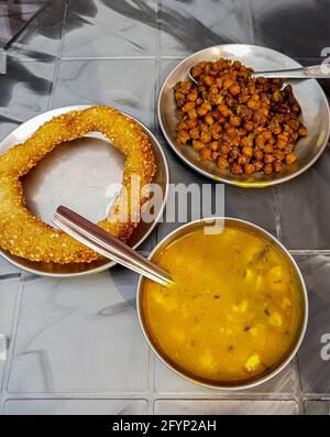 Nepalesisches Essen Frühstück mit Sel Roti und Kichererbsen. Ring Road in Kathmandu, Nepal. Stockfoto