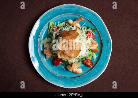 Blick von oben auf griechischen Salat auf einem blauen Teller. Stockfoto