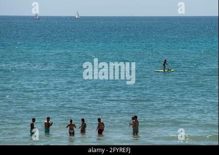 Alicante, Spanien. Mai 2021. Eine Frau, die am Strand El Postiguet in Alicante hohe Temperaturen genießt. Die valencianische Gemeinschaft hat am Montag neue Beschränkungsmaßnahmen gegen das Coronavirus (Covid-19) veröffentlicht, unter anderem gegen das Coronavirus, An den Stränden ist es nicht mehr notwendig, in den Ruhezeiten vor oder nach dem Baden eine Maske zu tragen und dabei den Mindestabstand von 1.5 Metern zu anderen Menschen, die nicht zusammen leben, mit einer maximalen Gruppe von 10 Personen einzuhalten. Quelle: Marcos del Mazo/Alamy Live News Stockfoto