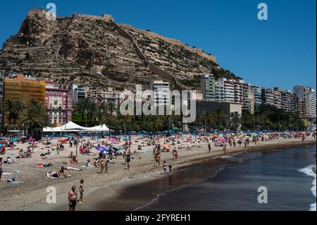 Alicante, Spanien. Mai 2021. Die Menschen genießen hohe Temperaturen in einem überfüllten El Postiguet Strand von Alicante. Die valencianische Gemeinschaft hat am Montag neue Beschränkungsmaßnahmen gegen das Coronavirus (Covid-19) veröffentlicht, unter anderem gegen das Coronavirus, An den Stränden ist es nicht mehr notwendig, in den Ruhezeiten vor oder nach dem Baden eine Maske zu tragen und dabei den Mindestabstand von 1.5 Metern zu anderen Menschen, die nicht zusammen leben, mit einer maximalen Gruppe von 10 Personen einzuhalten. Quelle: Marcos del Mazo/Alamy Live News Stockfoto