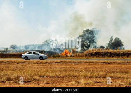 Johannesburg, Südafrika. Mai 2021. Ein Feuer brennt am Straßenrand in der Nähe der Gemeinde Soshanguve. Quelle: Christoph Soeder/dpa/Alamy Live News Stockfoto