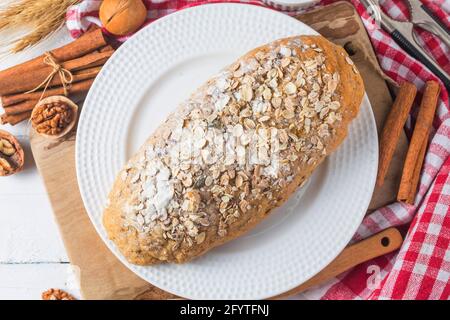 Blick von oben auf die Scheiben Vollkornbrot auf einer hölzernen Schneidebrett. Stockfoto