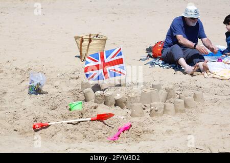 Camber, East Sussex, Großbritannien. 30. Mai 2021. Wetter in Großbritannien: Heißer und sonniger Morgen in Camber, wenn Dutzende von Besuchern an den goldenen Stränden des Ferienortes an der Südostküste ankommen. Union Jack Flagge und Sandburgen am Strand. Foto-Kredit: Paul Lawrenson /Alamy Live Nachrichten Stockfoto