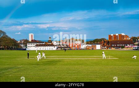 Cricket spielte unter dem Regenbogen Stockfoto