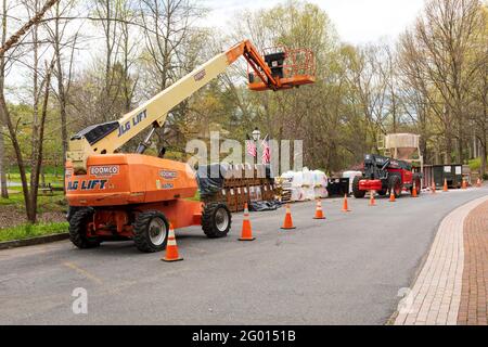 JONESBOROUGH, TN, USA--9 APRIL 2021: Industrielle Baumaschinen, einschließlich eines "Skyjack"-Lifts, eines Boomco JLG-Lifts und eines Mörtelmischers. Stockfoto