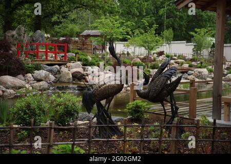 Nahaufnahme einer Parklandschaft mit Teich und Denkmälern im Topeka Zoo in Kansas USA Stockfoto