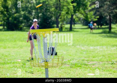 Junge Frau spielt fliegende Scheibe Sport-Spiel in der Natur Stockfoto