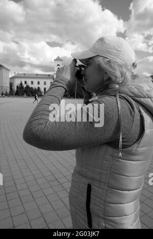 Das Mädchen fotografiert die Stadtlandschaft. St. Veronica's Day Photographer's Day . Stockfoto