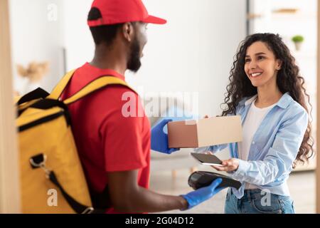 Porträt eines schwarzen Mannes, der die Kasse für die Zahlung hält Stockfoto