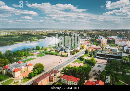 Rechyza, Weißrussland. Luftaufnahme Von Wohnhäusern Und Berühmten Sehenswürdigkeiten Der Stadt: Heilige Himmelfahrt Kathedrale Und Kirche Der Heiligen Dreifaltigkeit Im Sonnigen Sommer Stockfoto