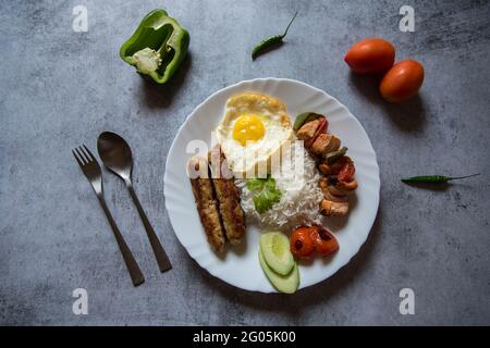 Mittelöstliches Gericht chelo Kebab aus Lammkebabs, die gegrillt werden und mit gegrillten Tomaten und Basmati oder Aromareis serviert werden. Draufsicht. Stockfoto