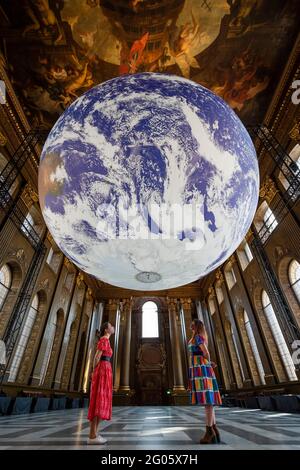 London, Großbritannien, 1. Juni 2021. Mitarbeiter sehen die „Gaia“ des Künstlers Luke Jerram, die in der Painted Hall des Old Royal Naval College in Greenwich installiert wurde. Die maßstabsgetreue Nachbildung der Erde dreht sich langsam, um ein Gefühl für den Overview-Effekt zu vermitteln, den Astronauten erleben, wenn sie die Erde aus dem All sehen. Das Werk ist bis zum 1. Juli zu sehen. Kredit: Stephen Chung / Alamy Live Nachrichten Stockfoto