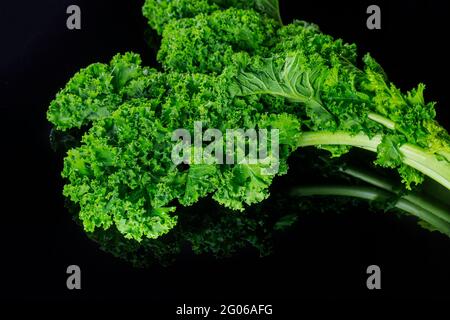 Frische grüne Grünkohl-Blätter auf schwarzem isolierten Hintergrund. Stockfoto