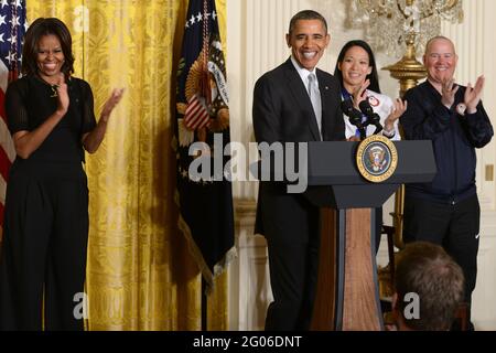 Berichtet: Präsident Barack Obama spricht bei einer Veranstaltung im Weißen Haus zu Ehren der US-Athleten der Olympischen und Paralympischen Winterspiele 2014 in Washington, D.C., 3. April 2014. Abgebildet sind mit Obama und der First Lady Michelle Obama Julie Chu von Fairfield, Conn, die mit der olympischen Eishockeymannschaft der Frauen Silber gewonnen hat, und (ganz rechts) Jon Lujan von Littleton, Colorado, Paralympics Alpine Skiing, ehemaliger Marine Corps Sergeant und Eröffnungszeremonie der Olympischen Winterspiele 2014 bei den USA. Stockfoto