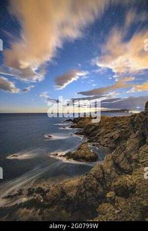 Cap Ras Küstenlandschaft, nachts, mit aufsteigendem Mond am Horizont (Costa Brava, Girona, Katalonien, Spanien) Stockfoto