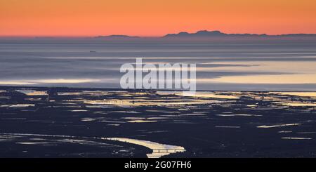 Sonnenaufgang vom Mont Caro mit Blick auf das Ebro-Delta und die Serra de Tramuntana am Horizont, auf Mallorca (Naturpark Els Ports, Tarragona, Spanien) Stockfoto