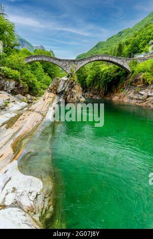 Blick auf die Brücke Ponte dei Salti zum Fluss Verzasca bei Lavertezzo - klarer und türkisfarbener Wasserlauf und Felsen im Tessin - Valle Verzasca - Tal in Tes Stockfoto