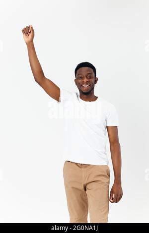 Afro-Amerikaner in weißem T-Shirt halten Hand über Kopf abgeschnitten Ansicht Stockfoto