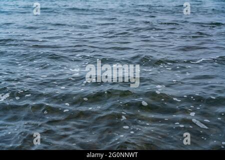 Wellen auf dem Meer mit schwarzem Sand Stockfoto