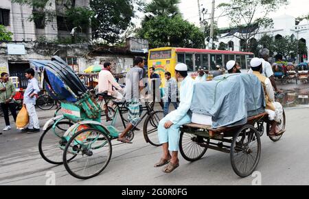 Bunte Rikschas durchstreifen die Straßen von Dhaka, Bangladesch. Stockfoto