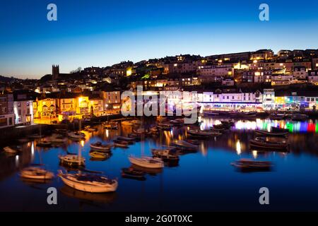 Blick auf die Boote rund um den Hafen in der Abenddämmerung am Fischerhafen von Brixham, Devon. Stockfoto