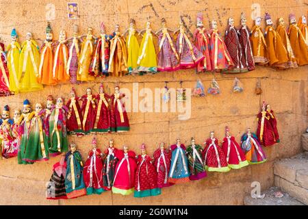 Traditionelle König und Königin, genannt Raja Rani, handgemachte Puppen oder Katputli-Sets hängen an der Wand im Jaislamer Fort, Rajasthan, Indien. Stockfoto