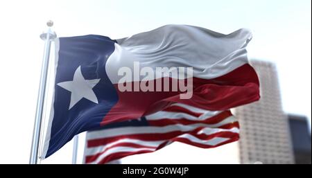 Die Staatsflagge von Texas flattern im Wind, die amerikanische Nationalflagge verschwimmt im Hintergrund. Demokratie und Unabhängigkeit. Amerikanisch-Süd-Centra Stockfoto