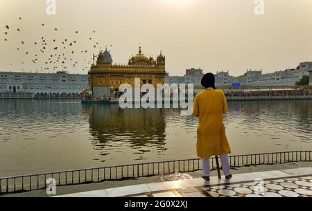 Amritsar, Indien - 06. November 2016: Selektiver Fokus eines nicht identifizierten männlichen Sicherheitsbeamten gegenüber dem berühmten Sikh Golden Tempel, der die trägt Stockfoto