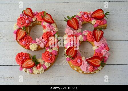 Geburtstagskuchen. Ungewöhnliche Erdbeeren in modernem Design. Frühling. Postkartenurlaub. Glückwünsche sind hell und kreativ. Schöner Kuchen in der Form Stockfoto