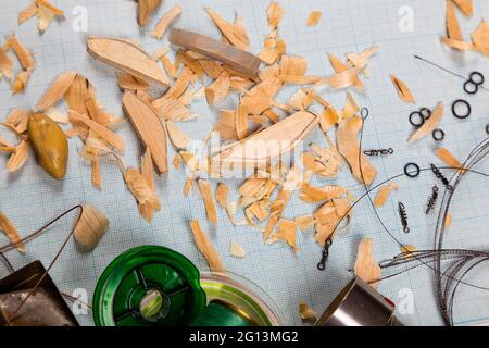Handgemachte hölzerne Fischerei tacles graph Papier Hintergrund mit Werkzeugen und Rohlinge. Mockap für Werbung und Veröffentlichung. Stockfoto