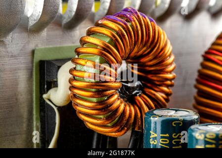 Eine Induktivität, Ringspule auf einem Ring mit sichtbarer Kupferrolle, gewickelt auf einer Magnetspule. Stockfoto