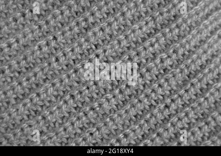 Nahaufnahme der Textur von silbergrauem Alpaka-Strickwollgewebe in Diagonalmustern Stockfoto