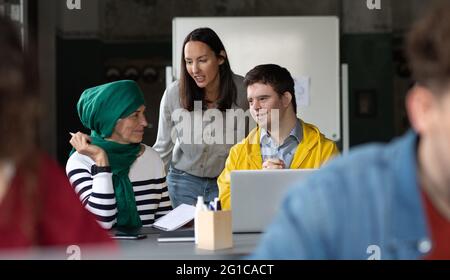 Down-Syndrom-Mann, der die Bildungsklasse im Gemeindezentrum besucht, einschließlich der Behinderten. Stockfoto