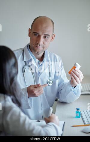 Hausarzt zeigt Kollegen neue Medizin und erklärt Indikationen und Kontraindikationen Stockfoto