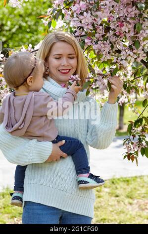 Mutter und Tochter auf einem Naturspaziergang im Spring Park. Kleine Mädchen und Mutter haben eine gute Zeit am Wochenende Aktivität Stockfoto